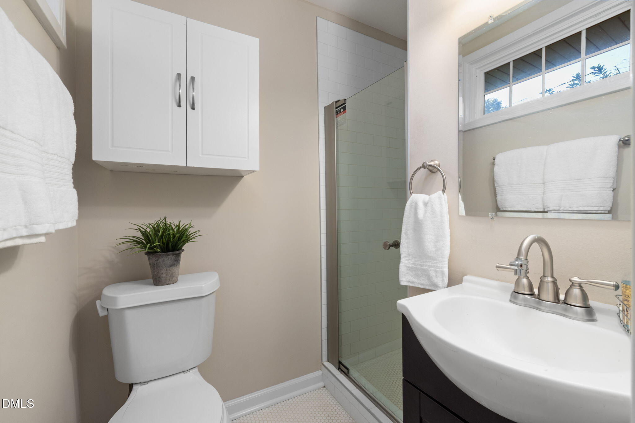 415 Bashford Road Raleigh, NC 27606 - Photo 21 of 33 a bathroom with a sink toilet and a mirror