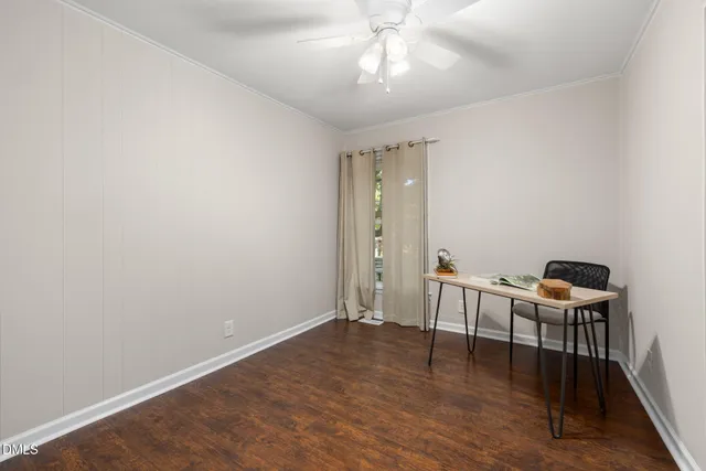 a view of a room with wooden floor lounge chair and windows