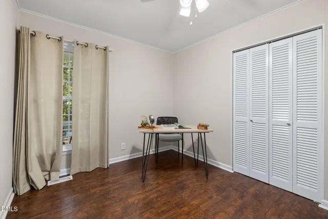a view of a workspace with furniture and a window