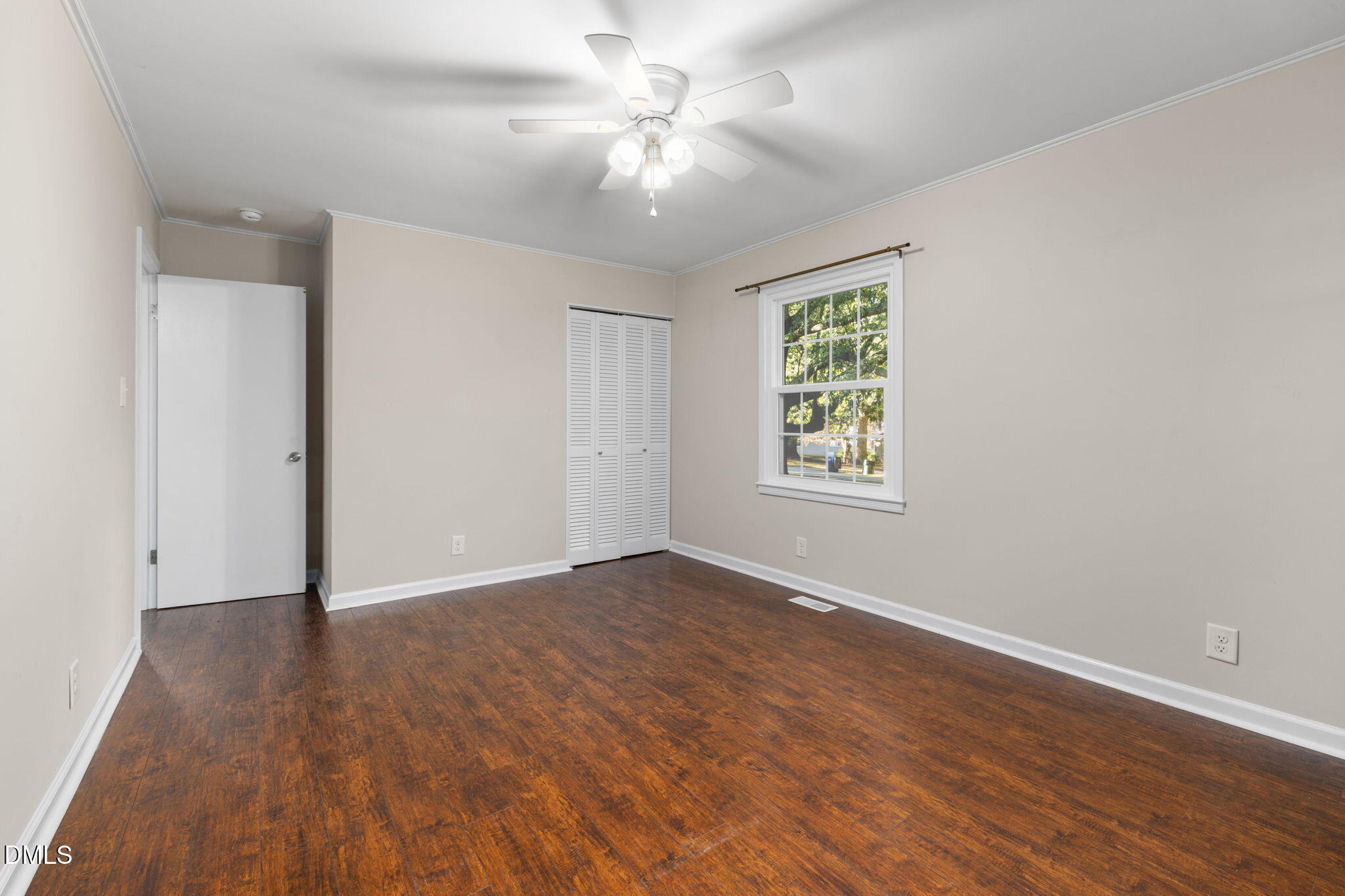 415 Bashford Road Raleigh, NC 27606 - Photo 27 of 33 an empty room with wooden floor chandelier fan and windows