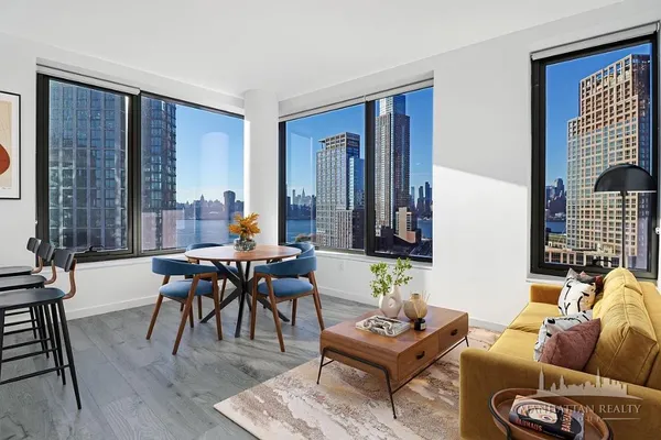 a living room filled with furniture and a large window