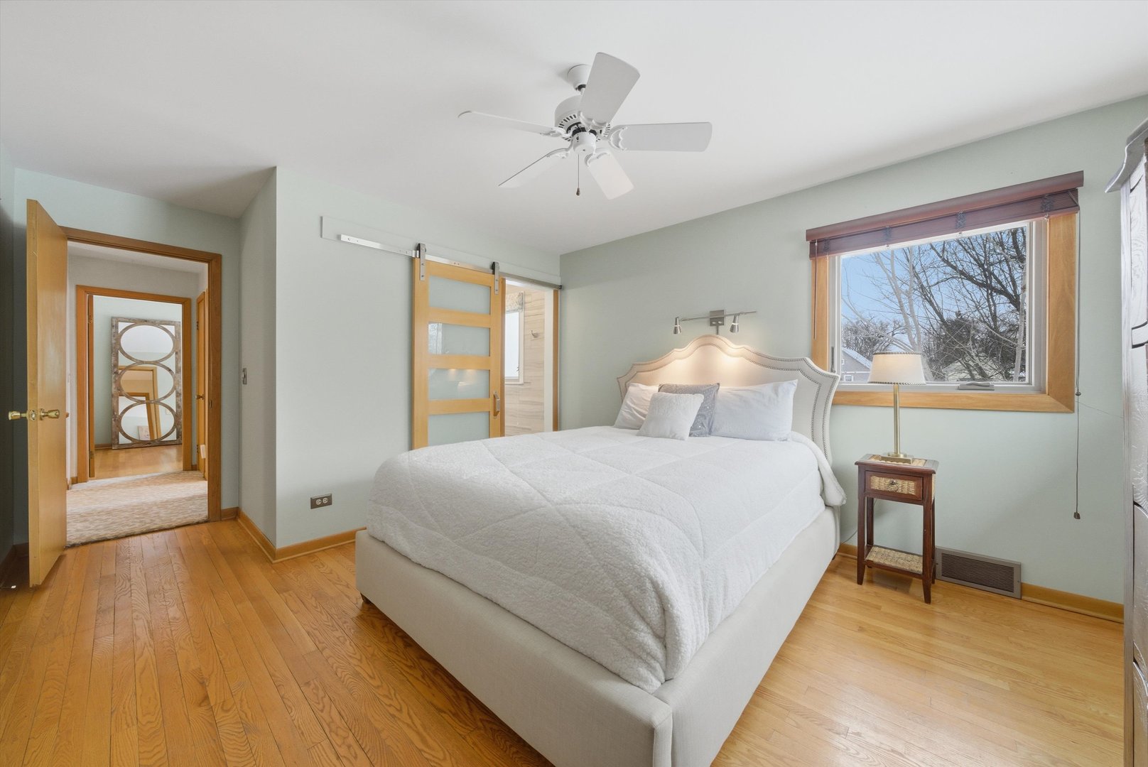 320 West Russell Street Barrington, IL 60010 - Photo 27 of 43 a spacious bedroom with a large bed and a chandelier