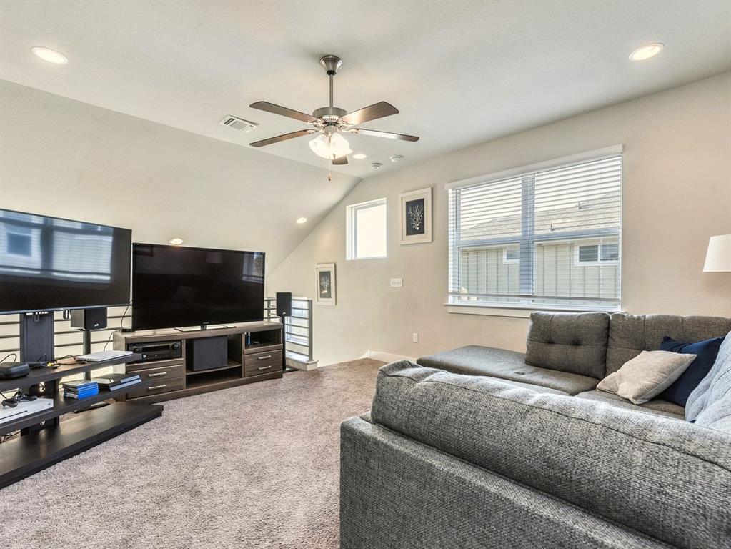 7001 Brick Slope Path Austin, TX 78744 - Photo 12 of 27 Living room featuring vaulted ceiling, light carpet, ceiling fan, and recessed lighting