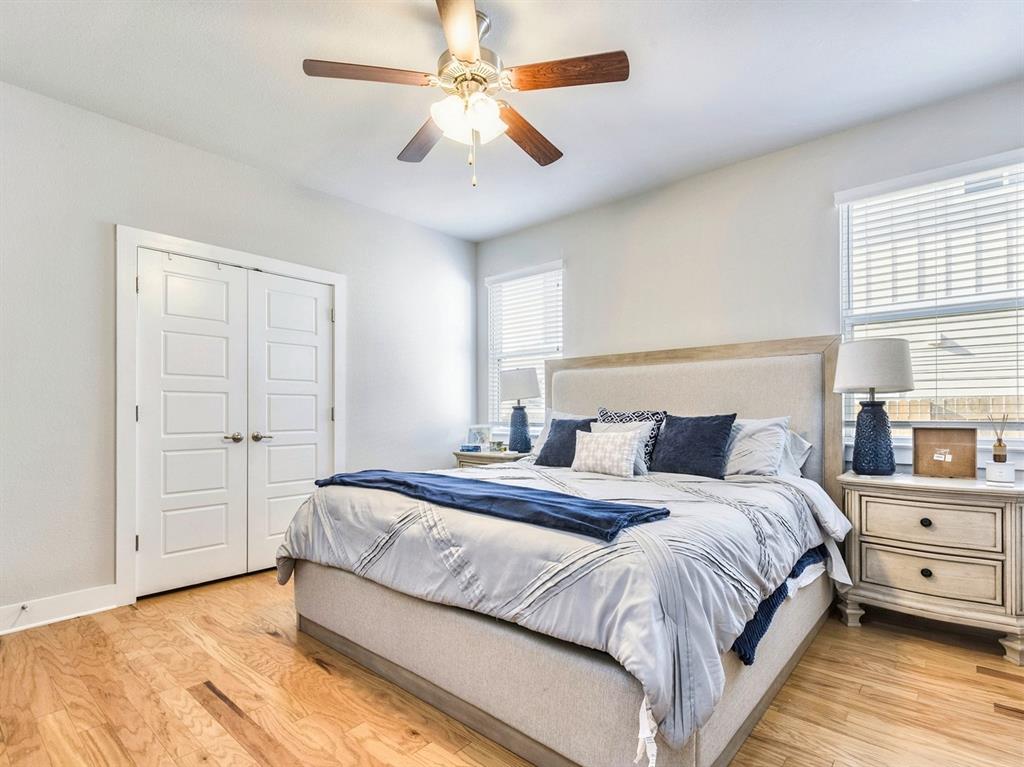 7001 Brick Slope Path Austin, TX 78744 - Photo 17 of 27 Bedroom featuring light wood-type flooring, a closet, and a ceiling fan