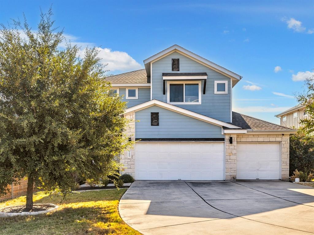 7001 Brick Slope Path Austin, TX 78744 - Photo 2 of 27 View of front of home featuring stone siding, concrete driveway, roof with shingles, and an attached garage