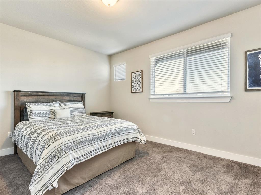 7001 Brick Slope Path Austin, TX 78744 - Photo 22 of 27 Bedroom featuring carpet floors and baseboards