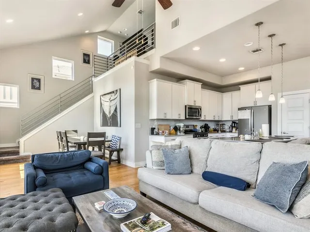 a living room with furniture and kitchen view