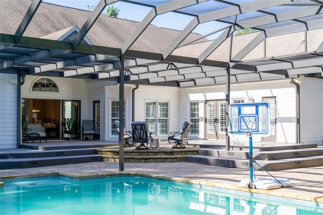 a kitchen with granite countertop a sink stove and cabinets
