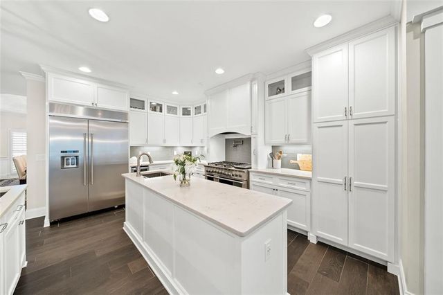 a bedroom with a bed and a view of kitchen