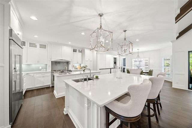a bathroom with a double vanity sink mirror double and shower
