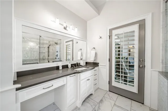 a front view of a house with a big yard and potted plants