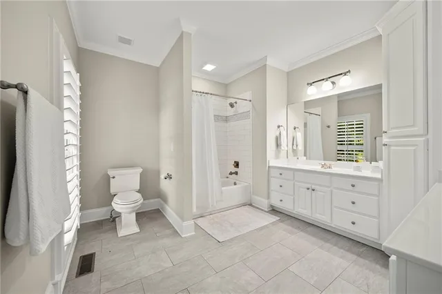 a front view of a house with a yard and potted plants