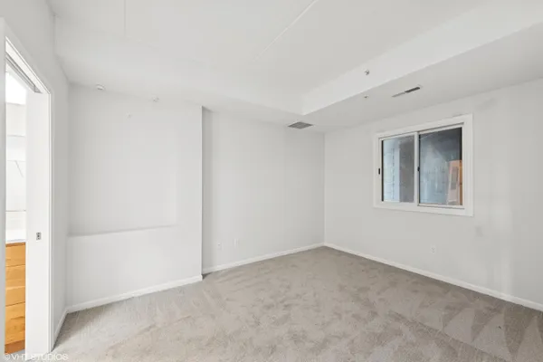 a living room with furniture floor to ceiling window and a floor to ceiling window