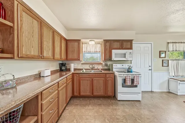 a kitchen with stainless steel appliances a refrigerator sink and cabinets