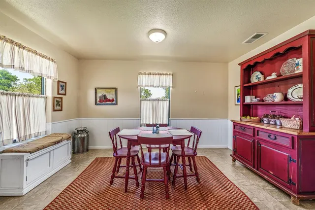 a open kitchen with stainless steel appliances a dining table and chairs
