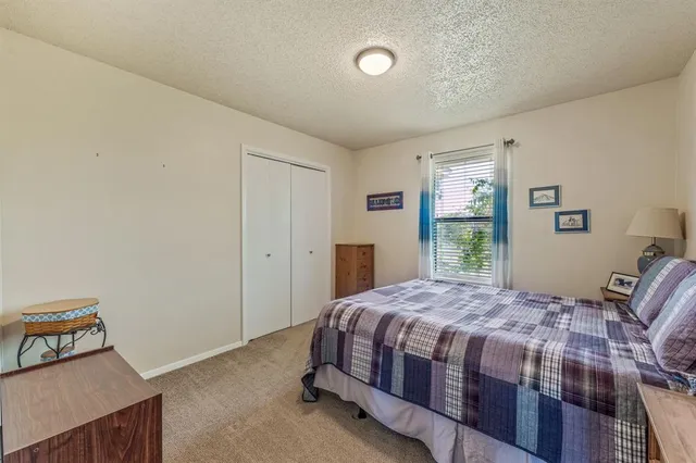 a bedroom with a bed next to a large window