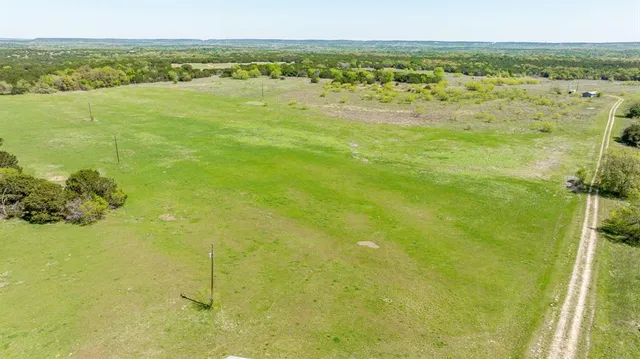 a view of a field with an ocean