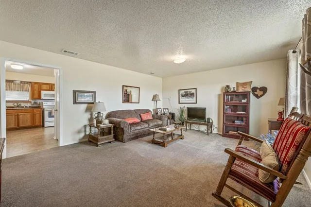 a living room with furniture and a gym equipment