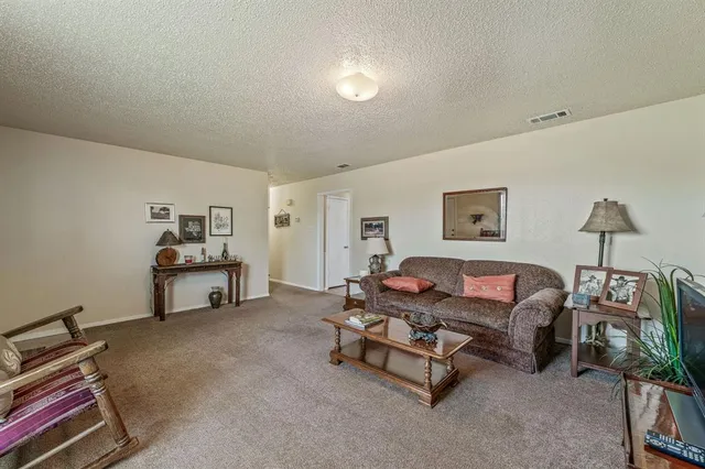 a living room with furniture gym equipment and a window