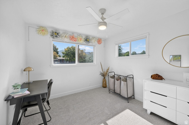 66 South 425 West Bountiful, UT 84010 - Photo 16 of 25 Bright room featuring two windows, neutral carpeting, a ceiling fan with integrated lighting, and white painted walls