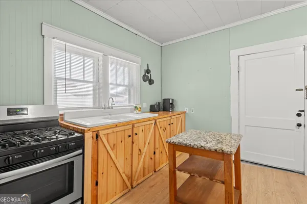 a kitchen with stainless steel appliances granite countertop a stove a sink and a refrigerator