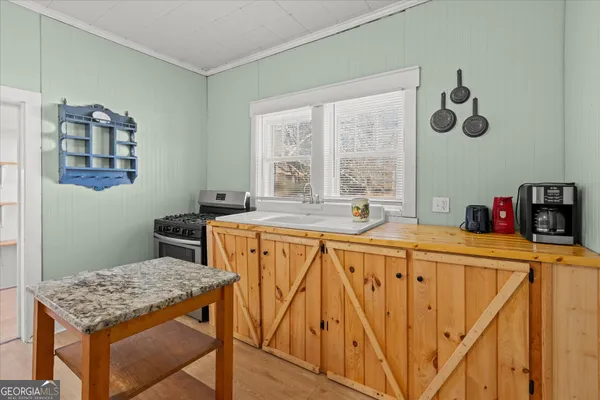 a kitchen with stainless steel appliances granite countertop a sink a stove and a refrigerator