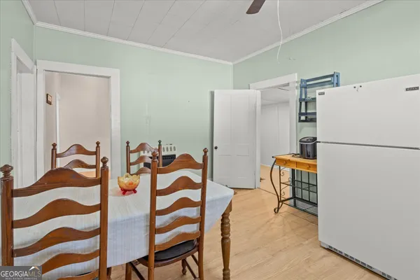 a dining room with furniture and a refrigerator