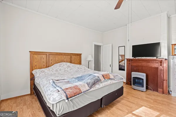 a spacious bedroom with a bed and a fireplace