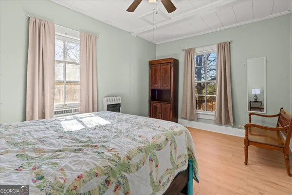 a bedroom with a bed and a chair with the outer view