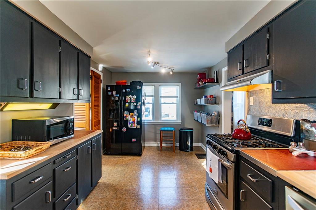 1146 Chestnut Street Monaca, PA 15061 - Photo 14 of 37 a kitchen with stainless steel appliances granite countertop a refrigerator and a stove top oven