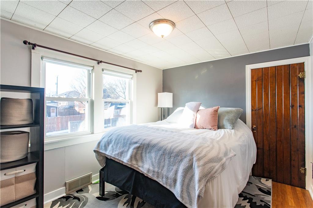 1146 Chestnut Street Monaca, PA 15061 - Photo 25 of 37 a bedroom with a bed window and a flat tv screen