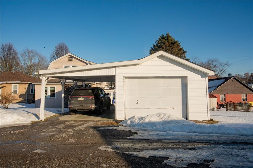 1146 Chestnut Street Monaca, PA 15061 - Photo 36 of 37 a front view of a house with a yard and garage
