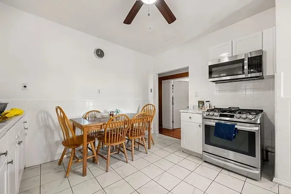 a view of kitchen with appliances cabinets and furniture