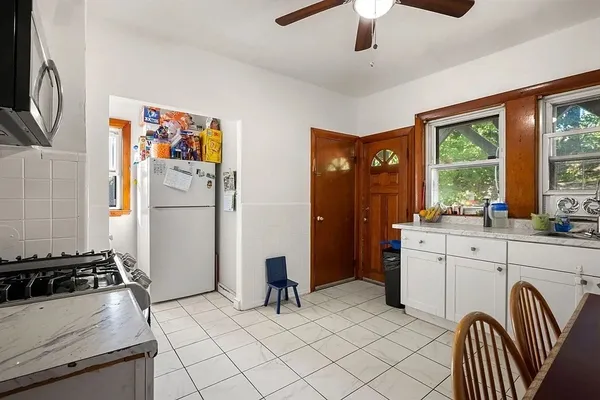 a kitchen with stainless steel appliances granite countertop a refrigerator and a stove top oven