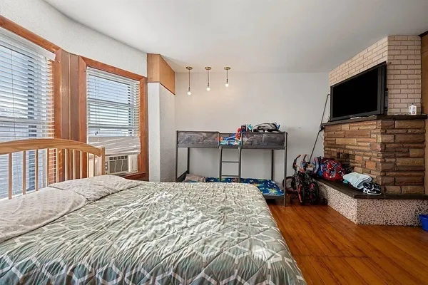 a bedroom with a bed and a flat screen tv