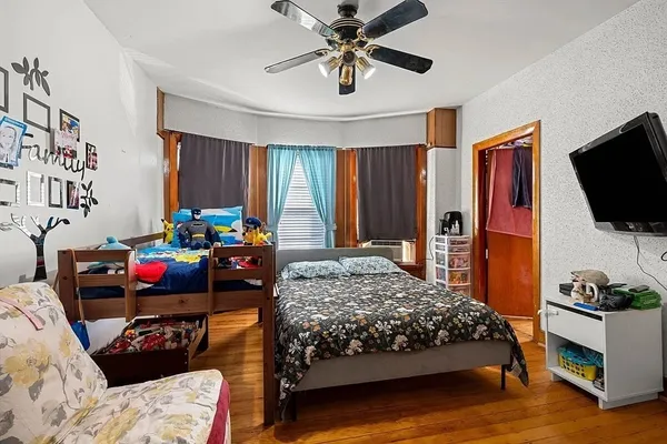 a bedroom with a bed and a flat screen tv