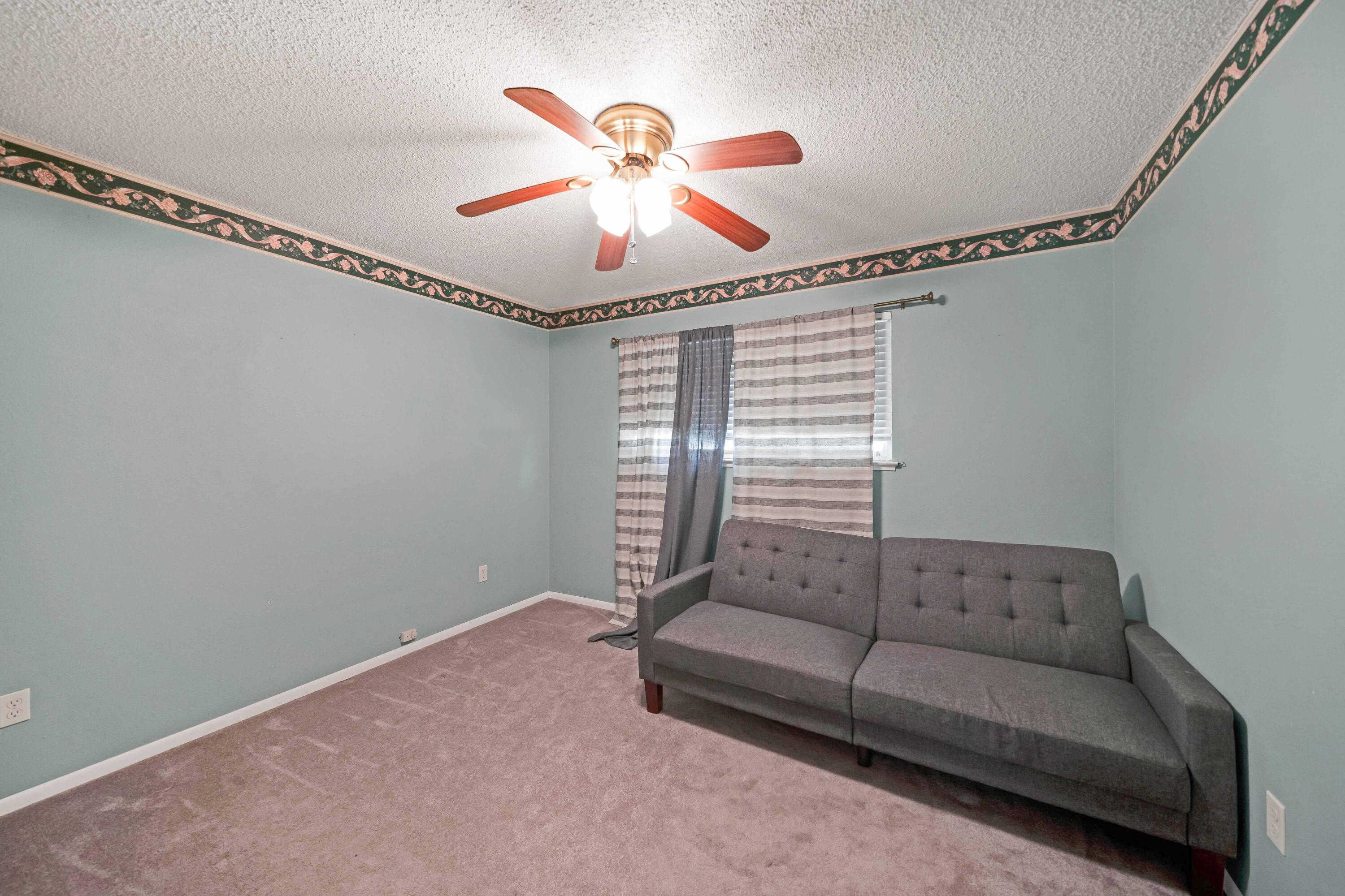 1945 Luning Street Red Bluff, CA 96080 - Photo 12 of 23 a living room with furniture and a chandelier