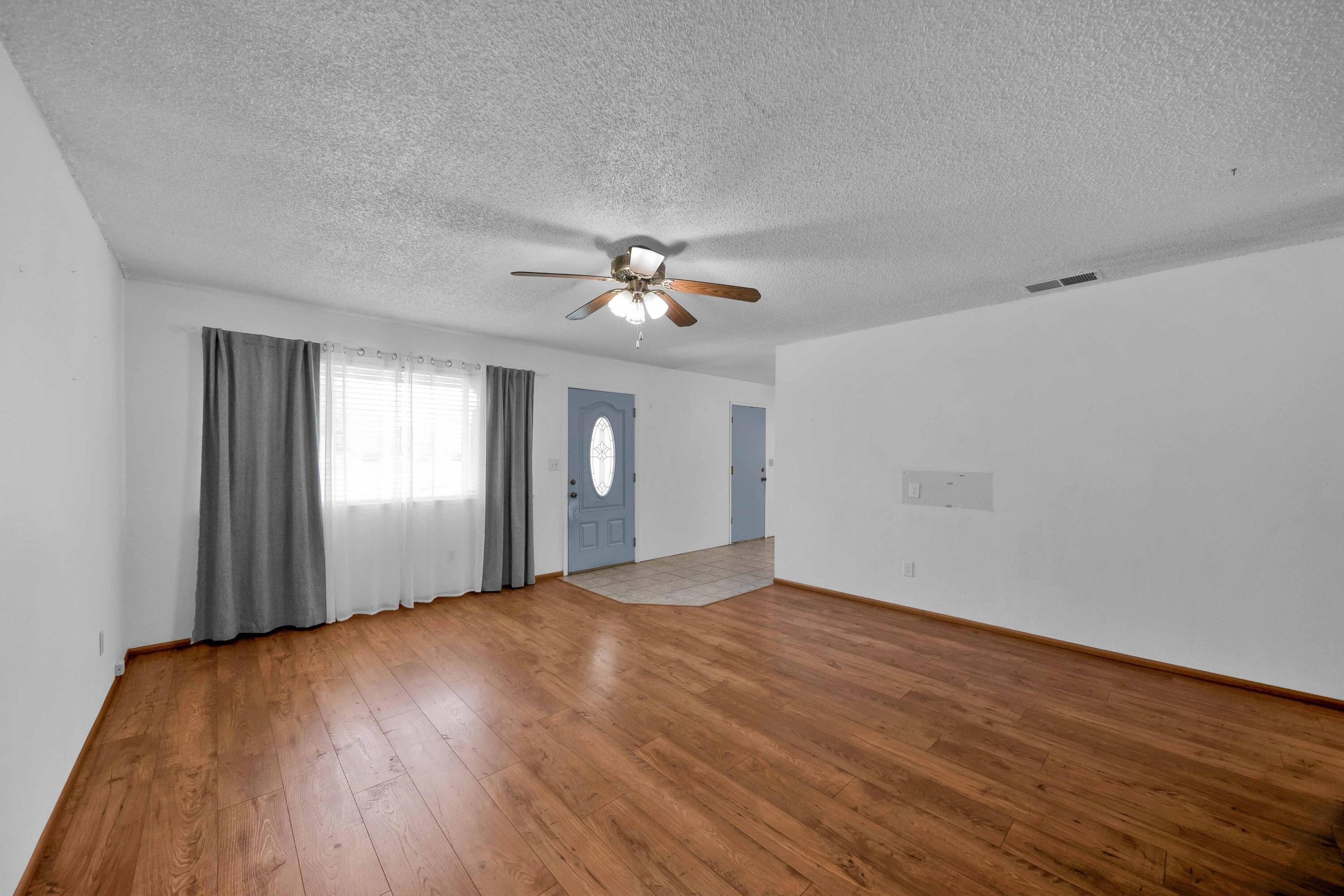 1945 Luning Street Red Bluff, CA 96080 - Photo 4 of 23 a view of an empty room with wooden floor and a window