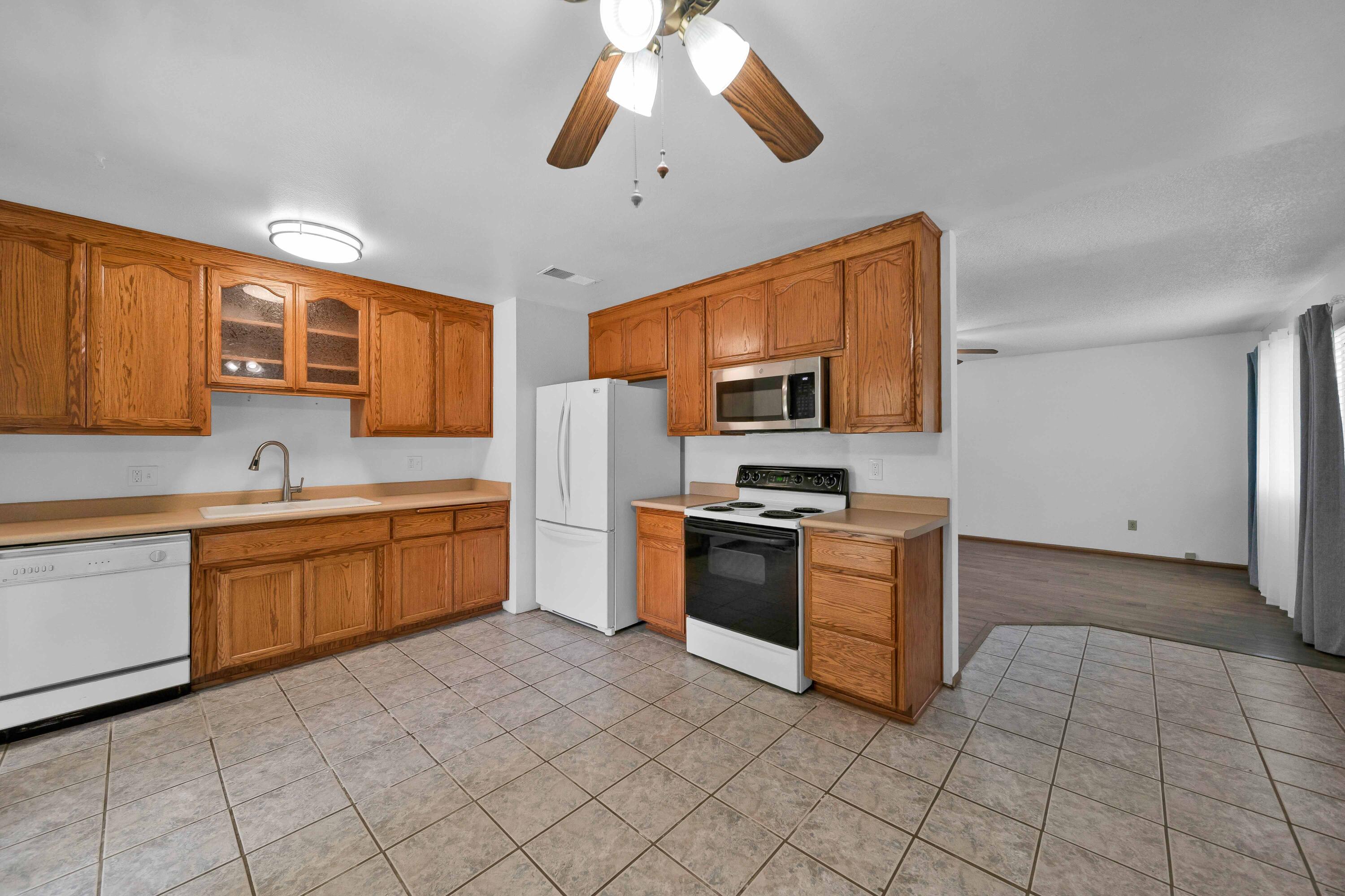 1945 Luning Street Red Bluff, CA 96080 - Photo 7 of 23 a kitchen with stainless steel appliances granite countertop a sink and cabinets