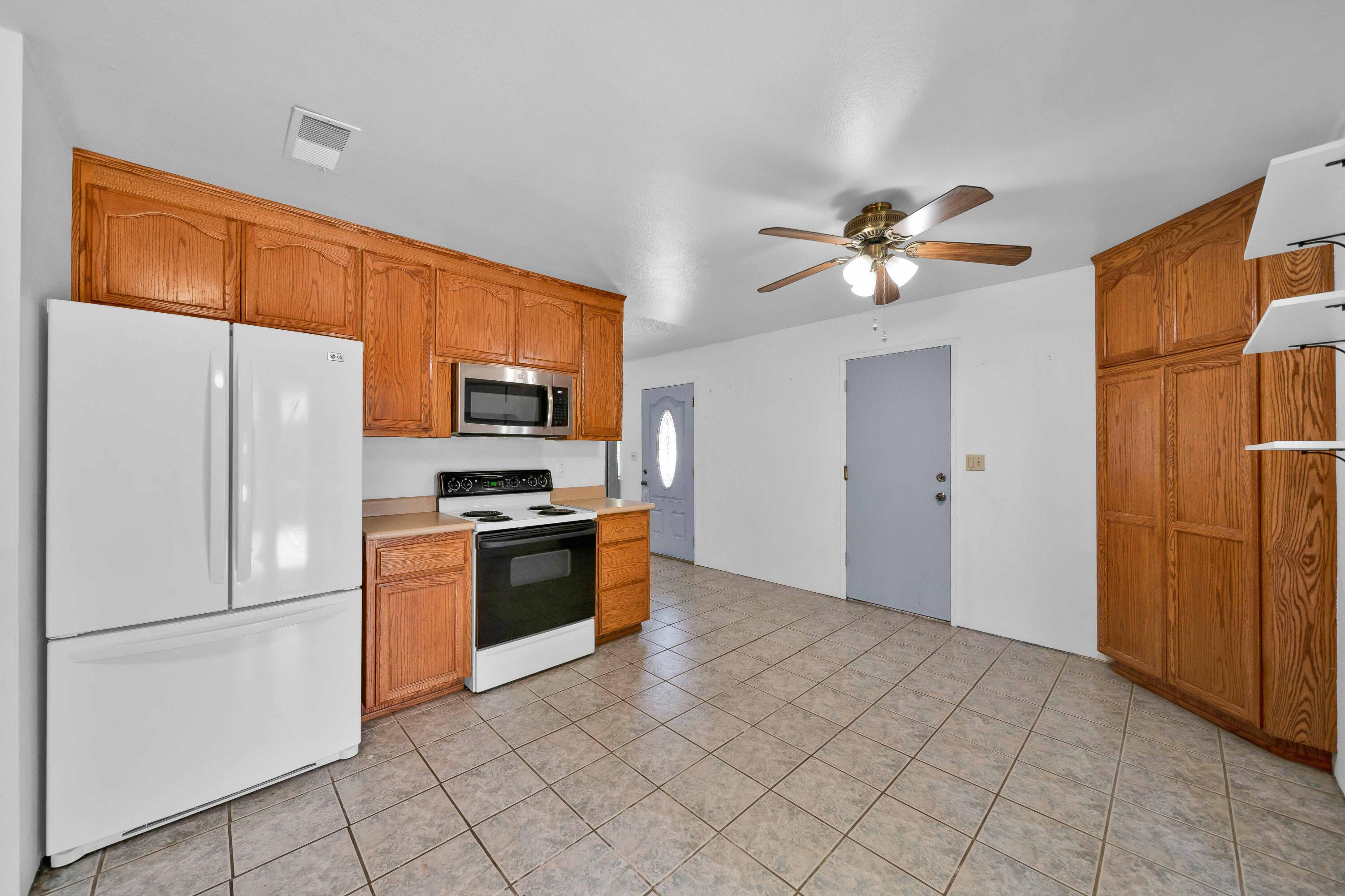 1945 Luning Street Red Bluff, CA 96080 - Photo 8 of 23 a kitchen with stainless steel appliances granite countertop a refrigerator a stove and a sink