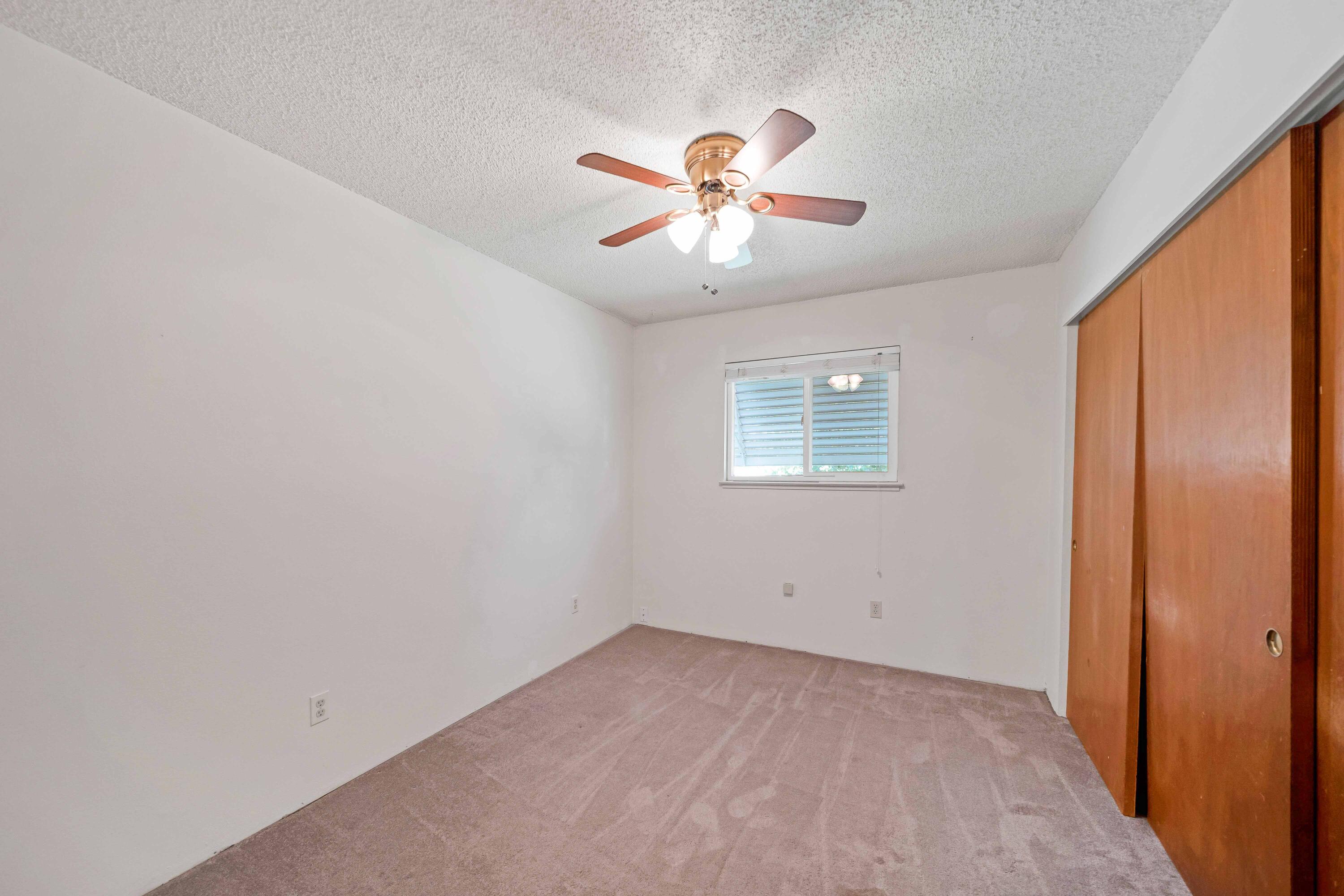 1945 Luning Street Red Bluff, CA 96080 - Photo 10 of 23 an empty room with windows and fan