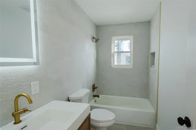 a bathroom with a toilet a sink and bathtub