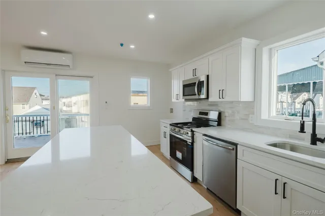 a kitchen with granite countertop a sink and a stove top oven