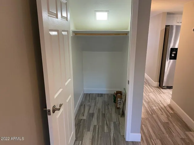 a view of hallway with wooden floor