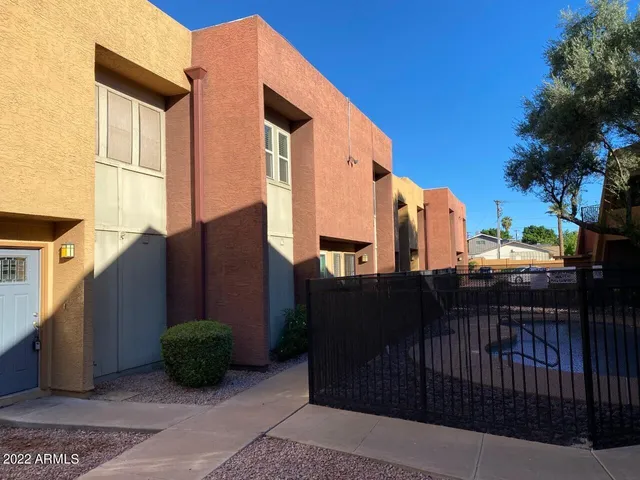 a view of a buildings with wooden fence