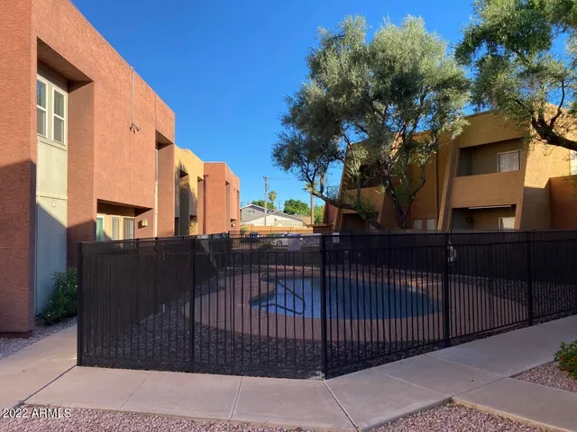 a view of a street with brick wall and building