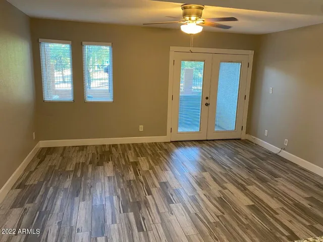 a view of wooden floor and windows in a room