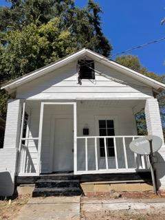a view of a house with a small deck