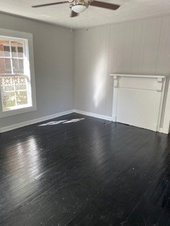 1429 25th Street Columbus, GA 31901 - Photo 3 of 17 an empty room with wooden floor cabinet and windows