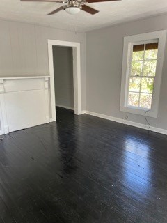 1429 25th Street Columbus, GA 31901 - Photo 4 of 17 an empty room with wooden floor cabinet and windows